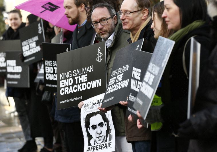 DATE IMPORTED: January 08, 2016 Demonstrators hold placards during a protest for Saudi blogger Raif Badawi, outside the Saudi Arabian Embassy in London, Britain January 8, 2016.