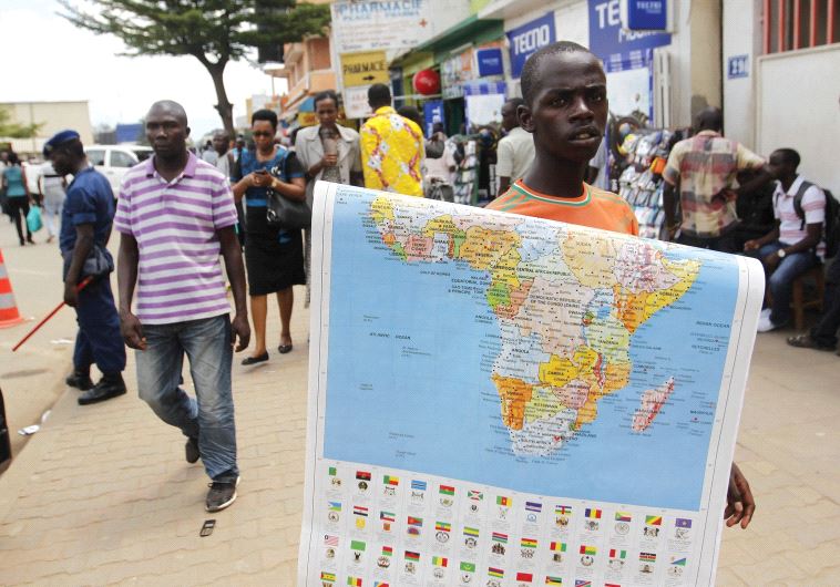 NEW FRIENDS everywhere for Israel. A vendor sells a map of Africa along the streets of Bujumbura, Burundi, last year.