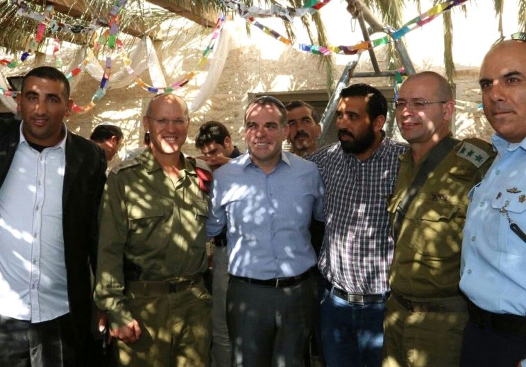 EFRAT COUNCIL head Oded Revivi hosts 30 Palestinians from the Bethlehem and Hebron area and representatives of the IDF and Border Police in his succa on Wednesday.