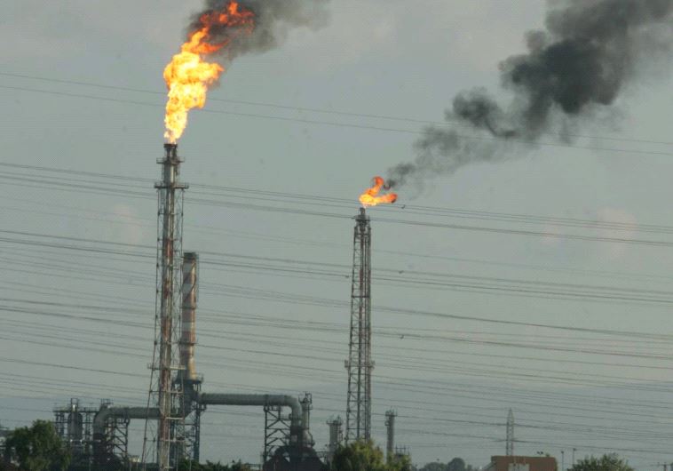 POLLUTING SMOKE rises yesterday from a Haifa refinery. (Alex Rozkovsky/Maariv)