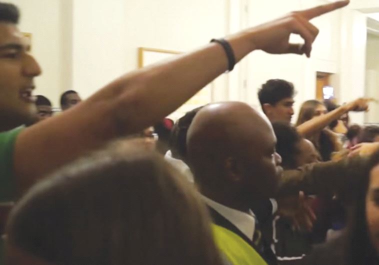 Protesters gesture as part of their efforts to stop an Israeli from speaking to students on the University College of London campus