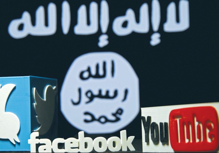 A 3-D PLASTIC representation of the Twitter, Facebook and YouTube logos is displayed in front an Isis flag. Islamic State is considered a pioneer among terrorist organizations regarding innovation in the cyber world.