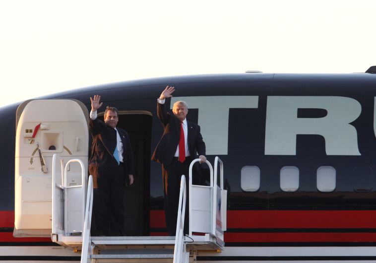 Governor Chris Christie (L) and current candidate Donald Trump (R) wave from Trump's jet. 