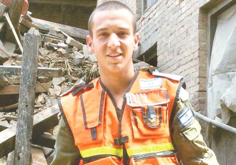 YOAV SASSON stands in front of rubble from a April 2015 earthquake in Nepal where he served as part of the IDF Home Front aid team.