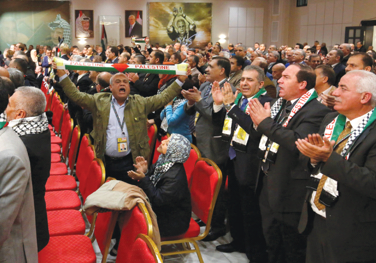 PARTICIPANTS CLAP and cheer before a speech by Palestinian Authority President Mahmoud Abbas during the Fatah Congress in Ramallah