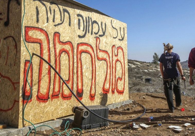 ‘THERE WILL be war over Amona,’ the graffiti reads at the outpost in the Binyamin region of Samaria in the West Bank