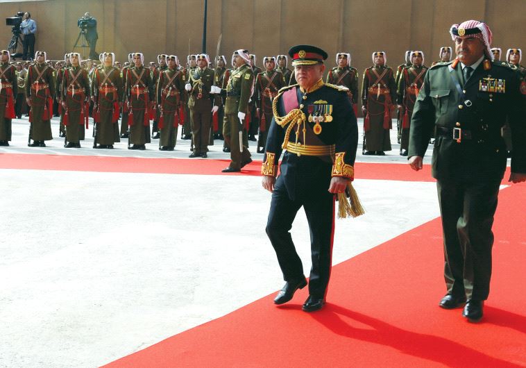 KING ABDULLAH reviews the honor guard during the opening ceremony of the first ordinary session of 18th Parliament in Amman
