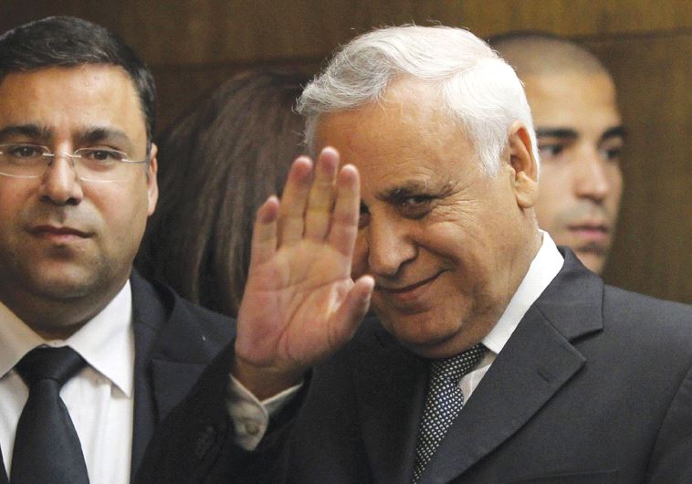 FORMER PRESIDENT Moshe Katsav waves to the press as he enters Tel Aviv District Court on December 30, 2010, to hear himself pronounced guilty of rape charges.