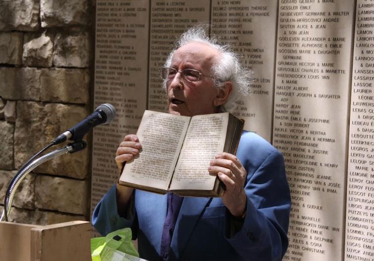 Dr. Lucien Lazare, member of the Jewish resistance in France and member of the Commission for the Designation of the Righteous, shows the Bible he received from Pastor Ducommun after liberation, Yad Vashem, 27 April 2010