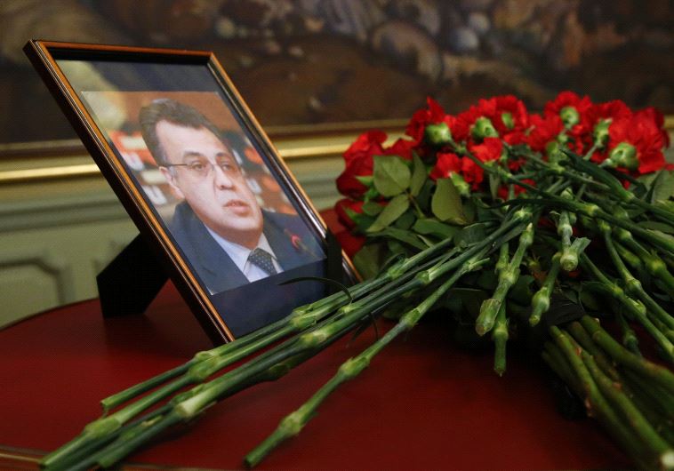 Flowers are placed near a portrait of murdered Russian ambassador to Turkey Andrei Karlov
