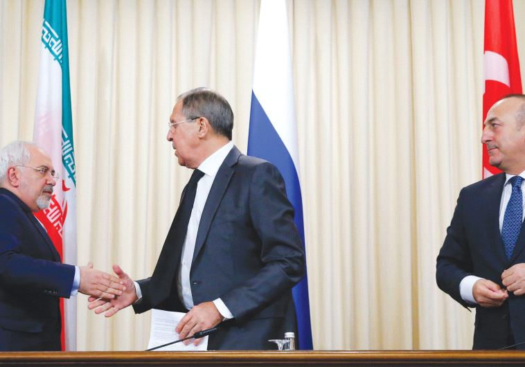 FOREIGN MINISTERS Sergei Lavrov of Russia (center) Mevlut Cavusoglu of Turkey (right) and Mohammad Zarif of Iran issued a declaration Tuesday on bringing an end to the Syrian civil war.