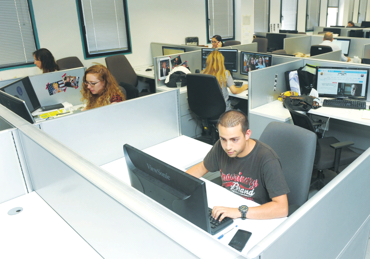 STAFFERS WORK in the offices of the soon-to-debut Israel Broadcasting Corporation in Modi’in.
