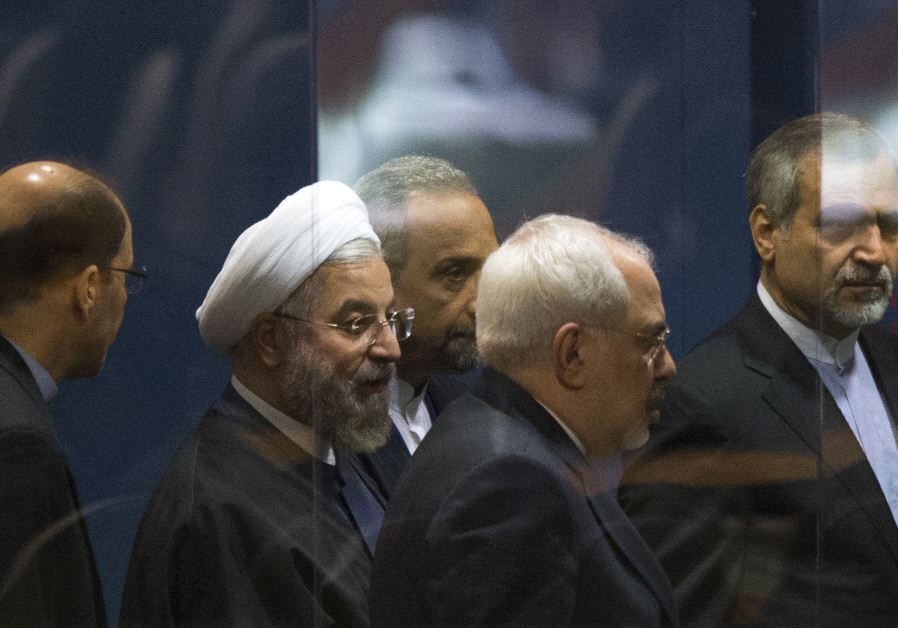 Iranian President Hassan Rouhani surrounded by goverment officials.