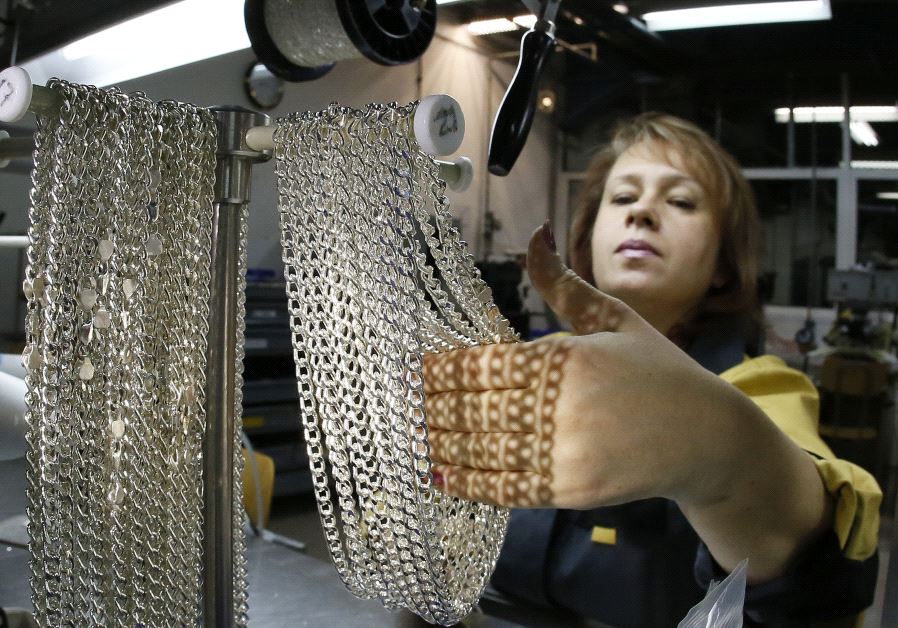 An employee takes silver chains at the jewelry departmen.