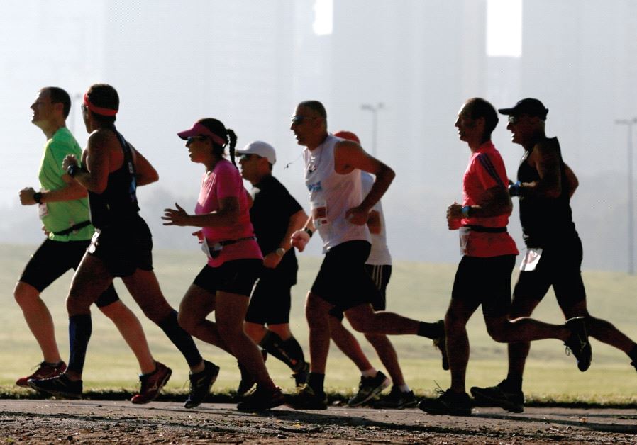 Runners warm up before a marathon in Tel Aviv, on February 26