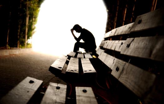 Depressed person broods in tunnel