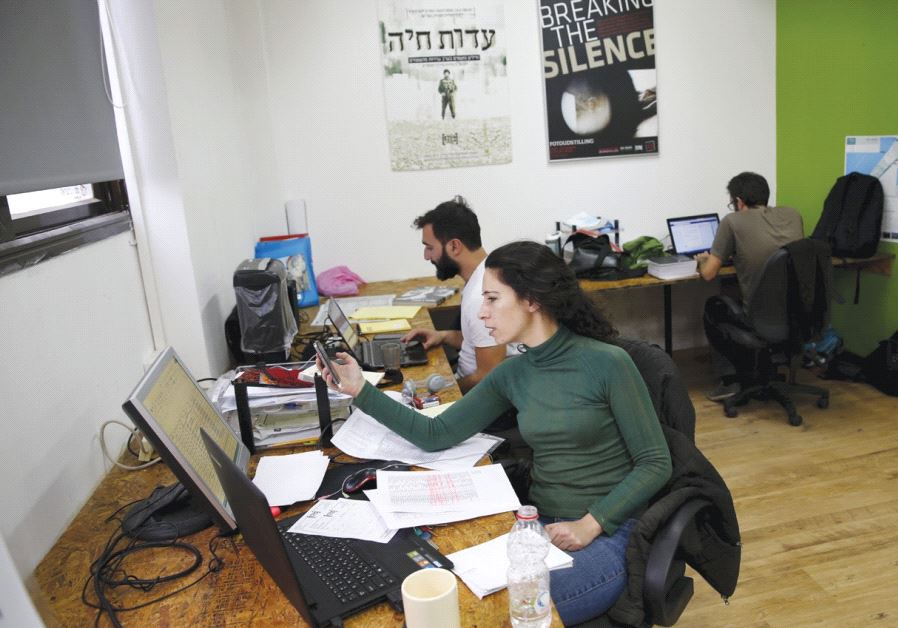 EMPLOYEES WORK at the offices of the Breaking the Silence NGO in Tel Aviv in 2015