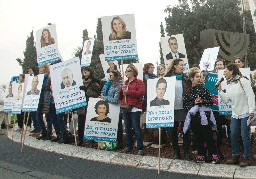 Members of the NGO Women Wage Peace stand near the Knesset in the capital last month