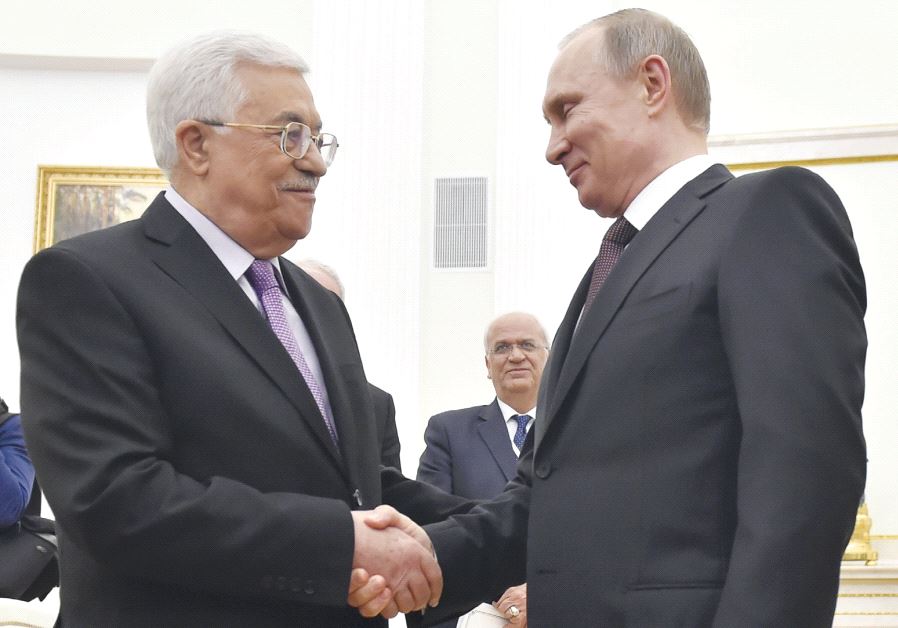 Russian President Vladimir Putin (right) shakes hands with PA President Mahmoud Abbas during their meeting at the Kremlin in Moscow, on April 18 last year