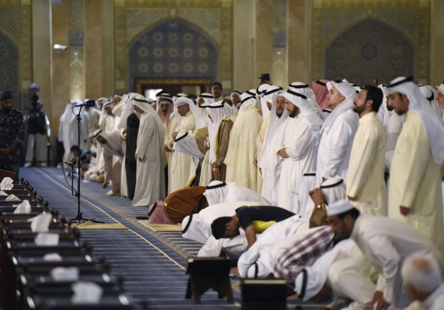 Sunni and Shi'ite worshippers, together with Emir Sheikh Sabah al Ahmed al Sabah, pray at the Grand Mosque of Kuwait, in Kuwait City [File]