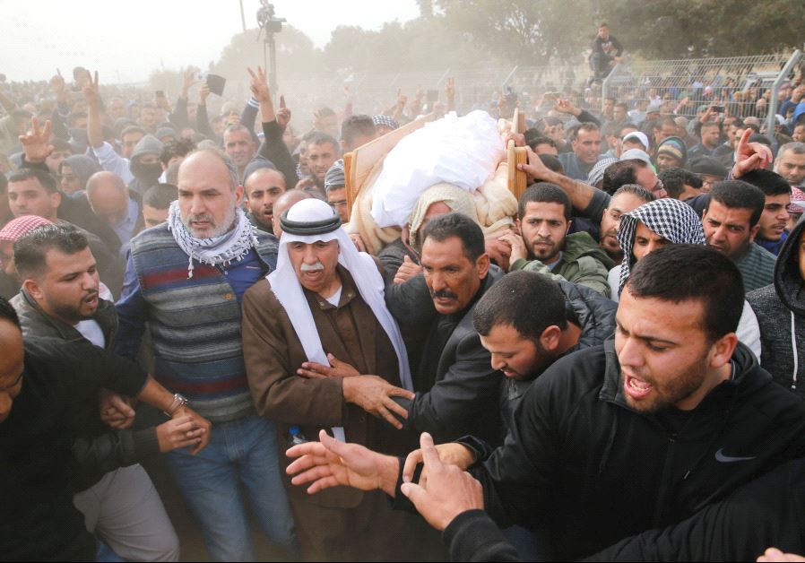 FRIENDS AND RELATIVES carry the body of Yacoub Abu al-Kiyan during his funeral in the Beduin village of Umm al-Hiran.
