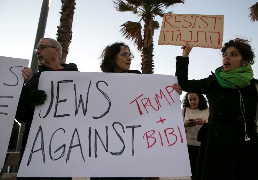 Protestors hold placards during a rally supporting refugees worldwide and in reaction to Trump's travel ban, outside the US embassy in Tel Aviv, Israel January 29, 2017