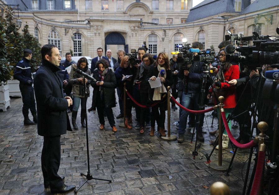 Benoit Hamon (L), French Socialist party's 2017 presidential candidate, talks to journalists as he leaves after a meeting with the French Prime Minister at the Hotel Matignon in Paris, France