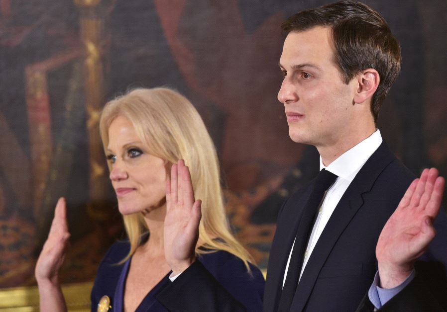 Counselor to the President Kelleyanne Conway (L) and Senior Advisor to the President Jared Kushner raise their hands during the swearing-in of senior staff in the East Room of the White House on January 22, 2017 in Washington, DC