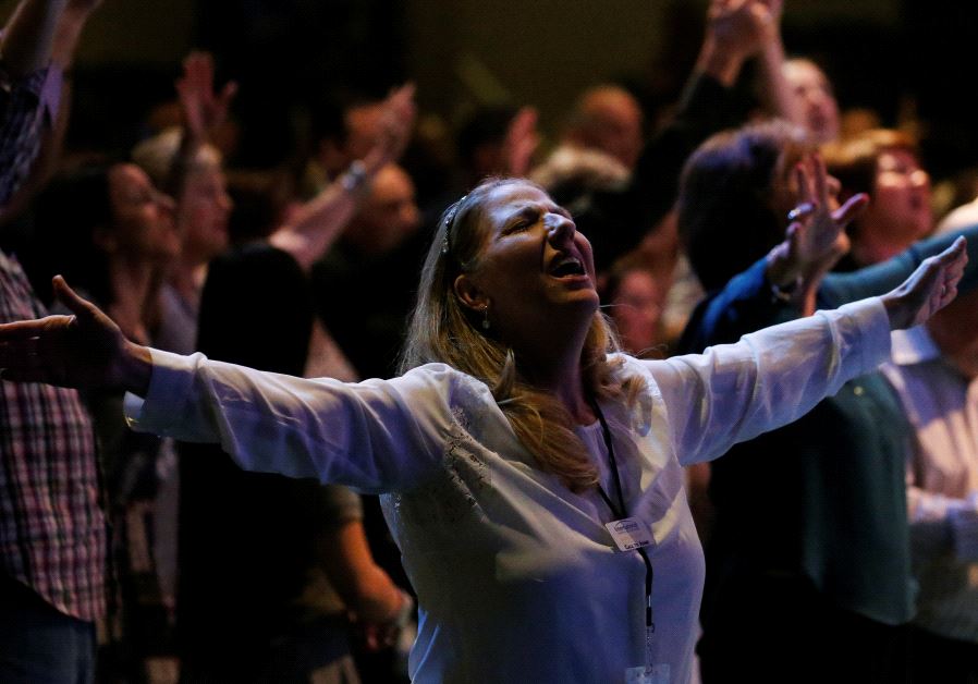 A woman prays in the room with then Republican presidential nominee Donald Trump during church service at the International Church of Las Vegas in Las Vegas, Nevada, US October 30 2016.
