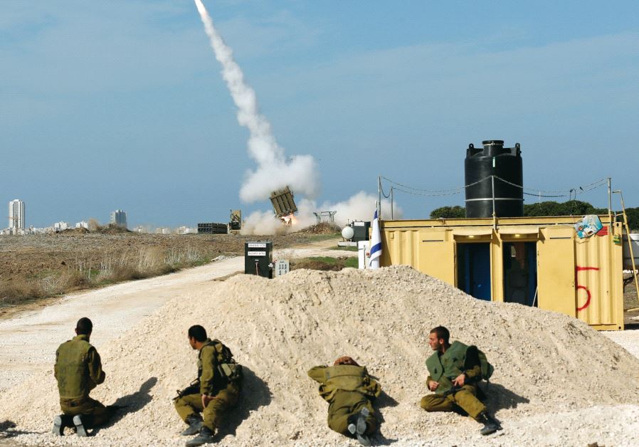 Israeli soldiers watch as an Iron Dome launcher fires an interceptor rocket near the southern city of Ashdod in 2012