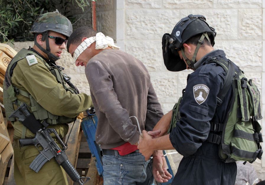 IDF arrest a suspected Palestinian during a raid in Hebron