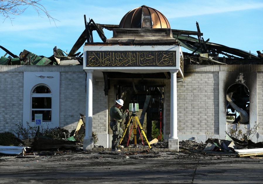 A security official investigates the aftermath of a fire at the Victoria Islamic Center mosque in Victoria, Texas January 29, 2017. 
