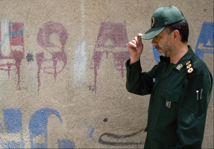 A MEMBER of Iran’s Revolutionary Guard walks past anti-US graffiti at a ceremony in 2008 to mark the anniversary of the death of Islamic Republic founder Ayatollah Ruhollah Khomeini.