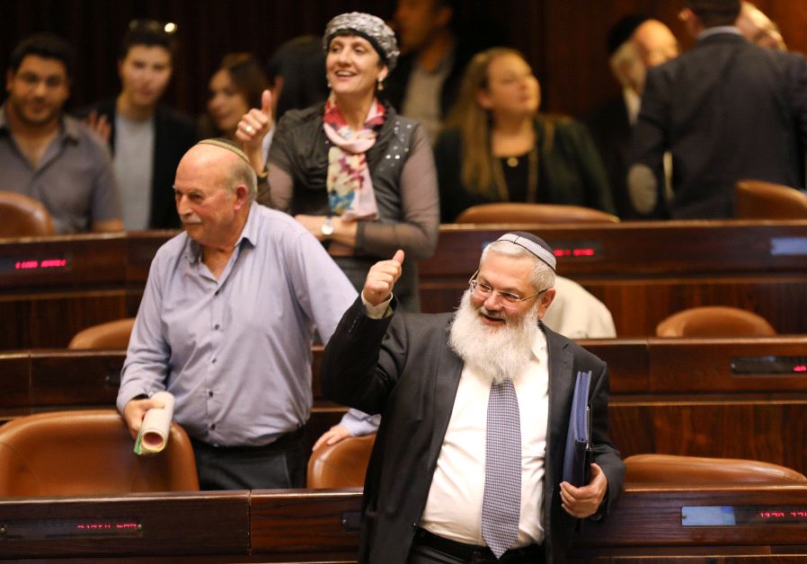 Deputy Defense Minister, Eli Ben-Dahan (front) and other Israeli lawmakers give a thumbs up gesture as they attend a vote on the settlement bill at the Knesset on Feb. 7, 2017