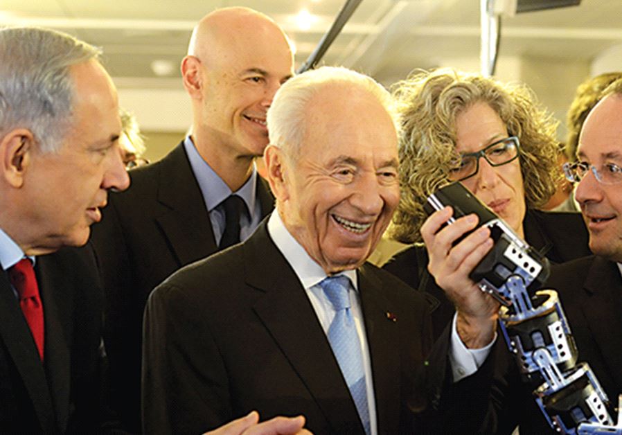 PRIME MINISTER Benjamin Netanyahu, late former president Shimon Peres and French President François Hollande. Interpreter Gisele Abazon stands behind Peres and Hollande.