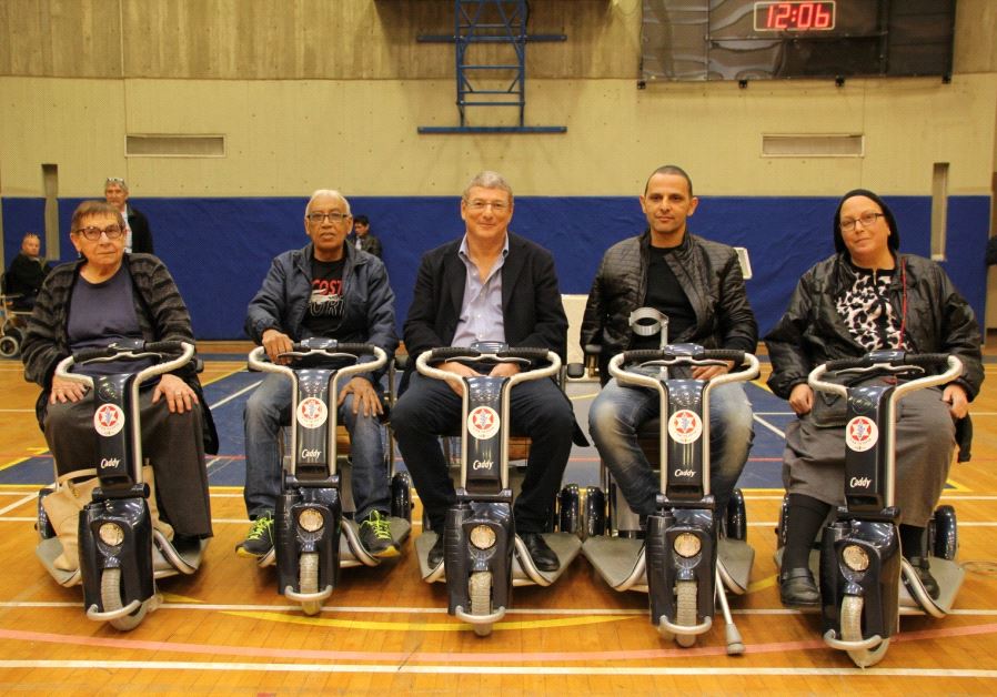 Disabled IDF veterans with their newly donated scooters