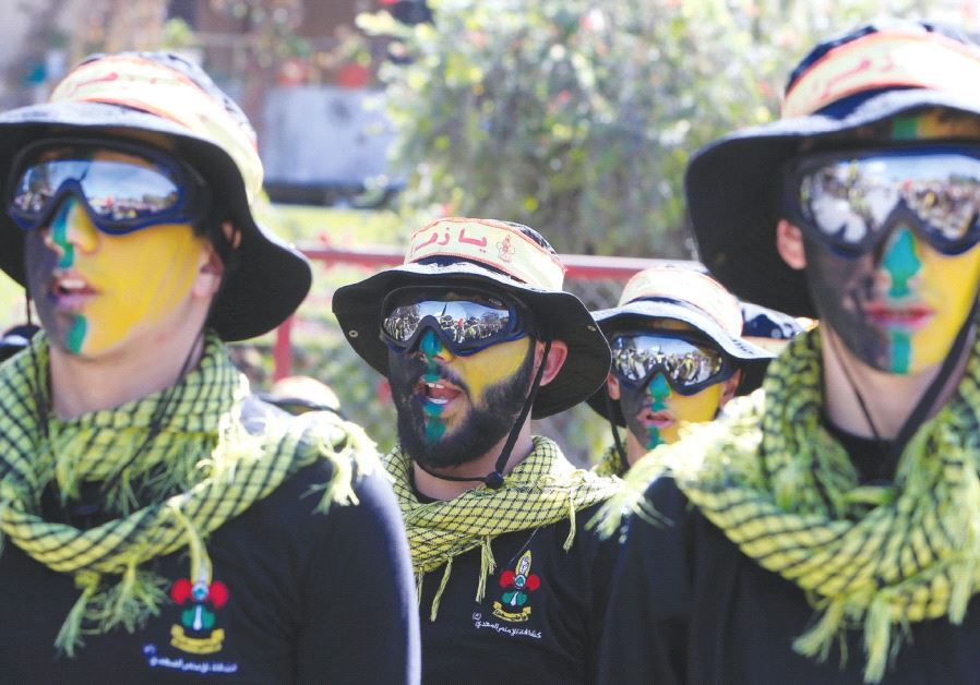 HEZBOLLAH MEMBERS march during a religious procession in Nabatiyeh in southern Lebanon last October