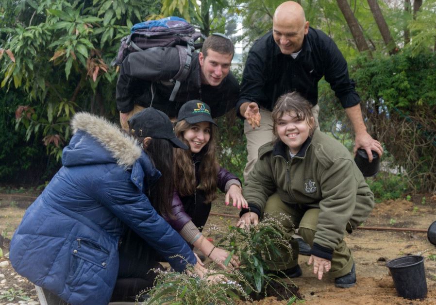 Special in Uniform participants and volunteers plant a tree in honor of Tu Bishvat 