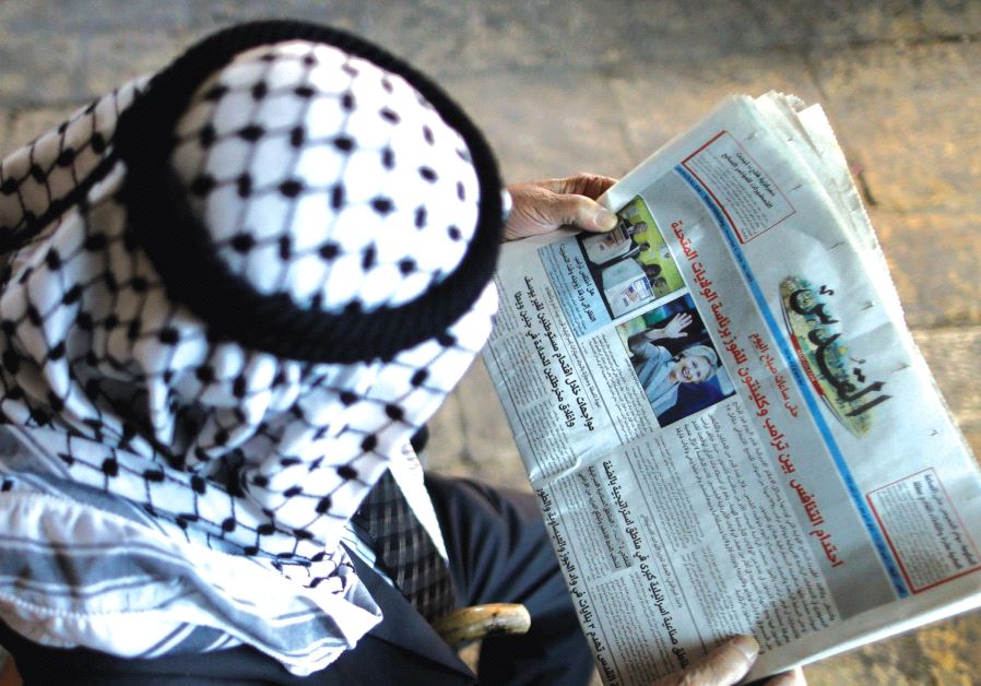 A Palestinian man from Al-Khalil reads ‘Al-Quds’ newspaper.