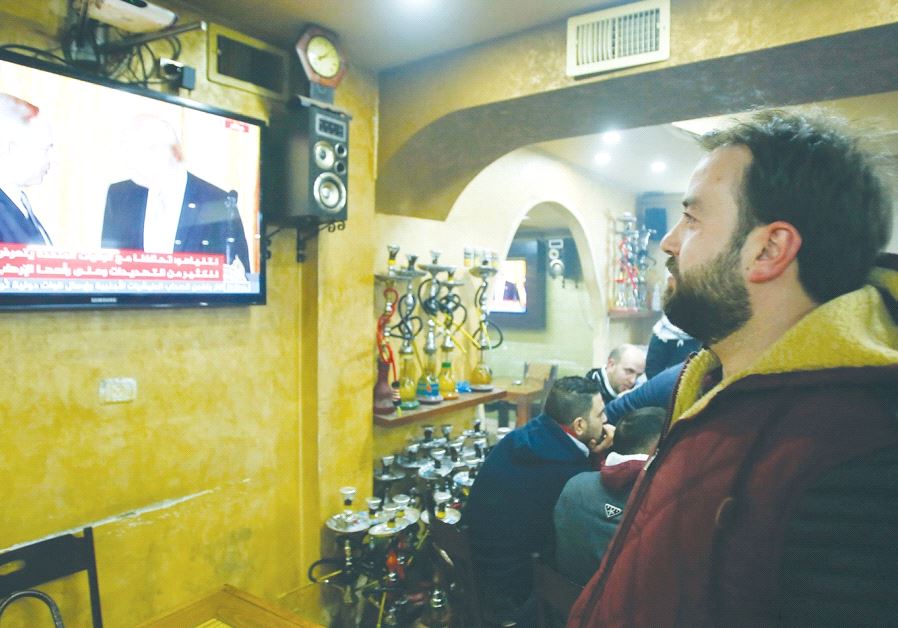 A Palestinian man in a cafe in Hebron watches Prime Minister Benjamin Netanyahu and US President Donald Trump’s joint press conference