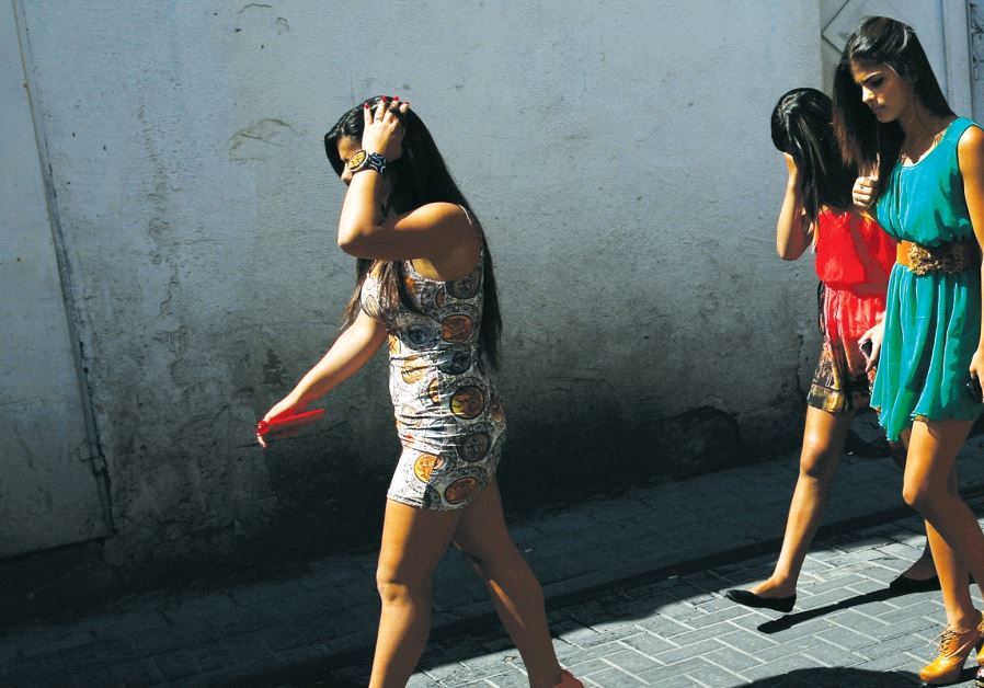 Dressed-up Israeli Arab Christian women walk to join an Easter Monday parade in Jaffa, in 2014