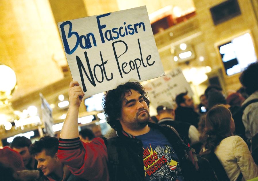 A man holds a sign during a ‘Muslim and Jewish Solidarity Protest’ against the policies of US President Donald Trump and Prime Minister Benjamin Netanyahu at Grand Central Station in Manhattan on Wednesday