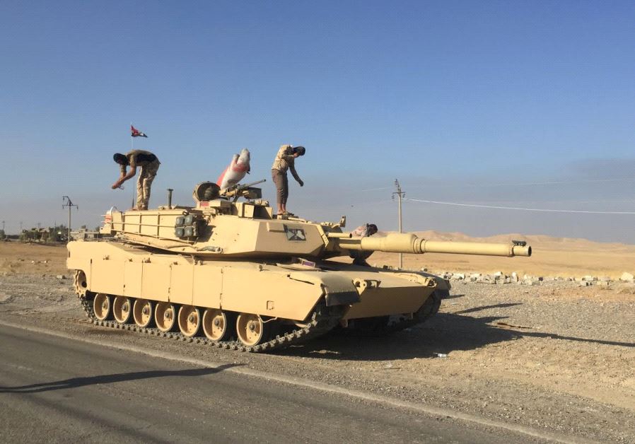 Iraqi armed forces stand on their US-made battle tank. As the army moves into western Mosul it will face stiffer resistance and its armored units will find difficulty maneuvering. 