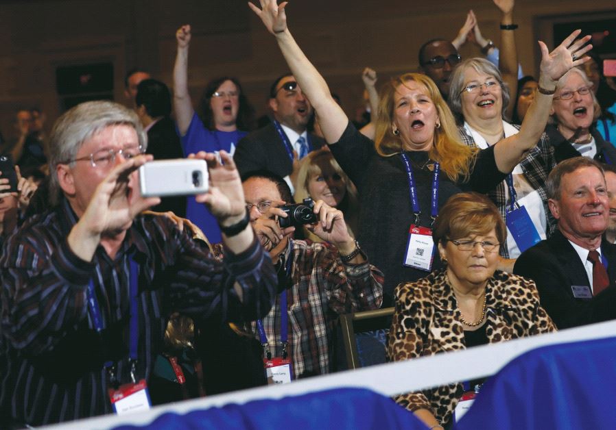 People cheer as US President Donald Trump addresses the Conservative Political Action Conference (CPAC) in Oxon Hill, Maryland