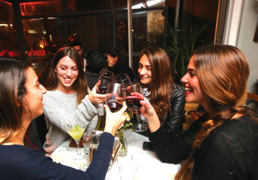 Clinking glasses at chef Assaf Granit’s ‘Wine Bar.’