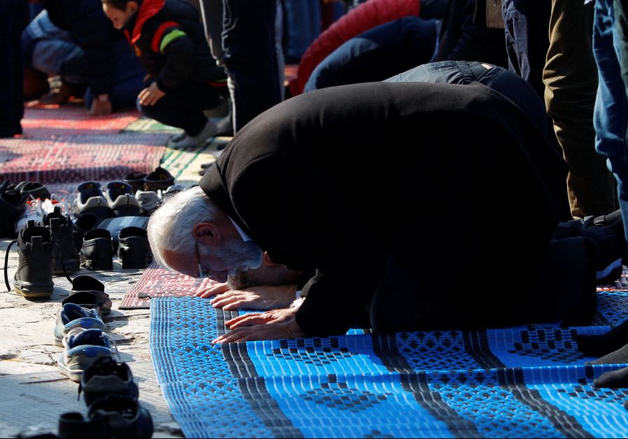 Muslims pray during Friday prayers on the street near the Murat Pasha Mosque in the old town of Skopje, Macedoni