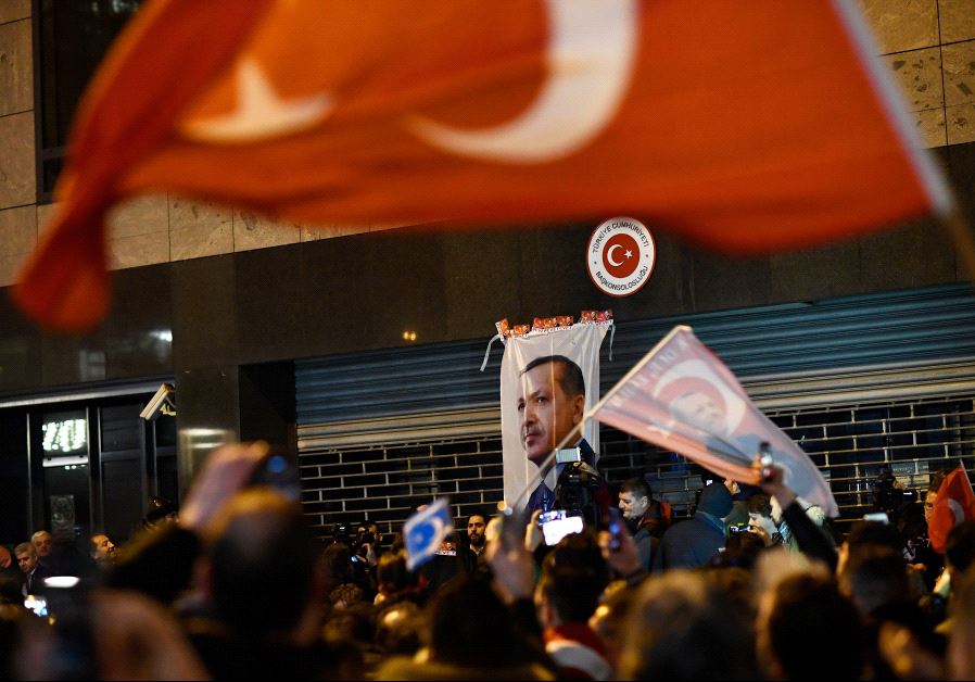 Demonstrators gather ahead of clashes with riot police outside the Turkish consulate in Rotterdam, Netherlands
