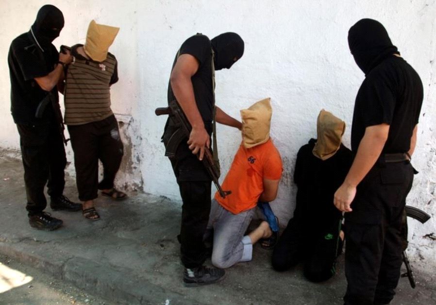 Hamas operatives prepare to execute alleged collaborators in the Gaza Strip