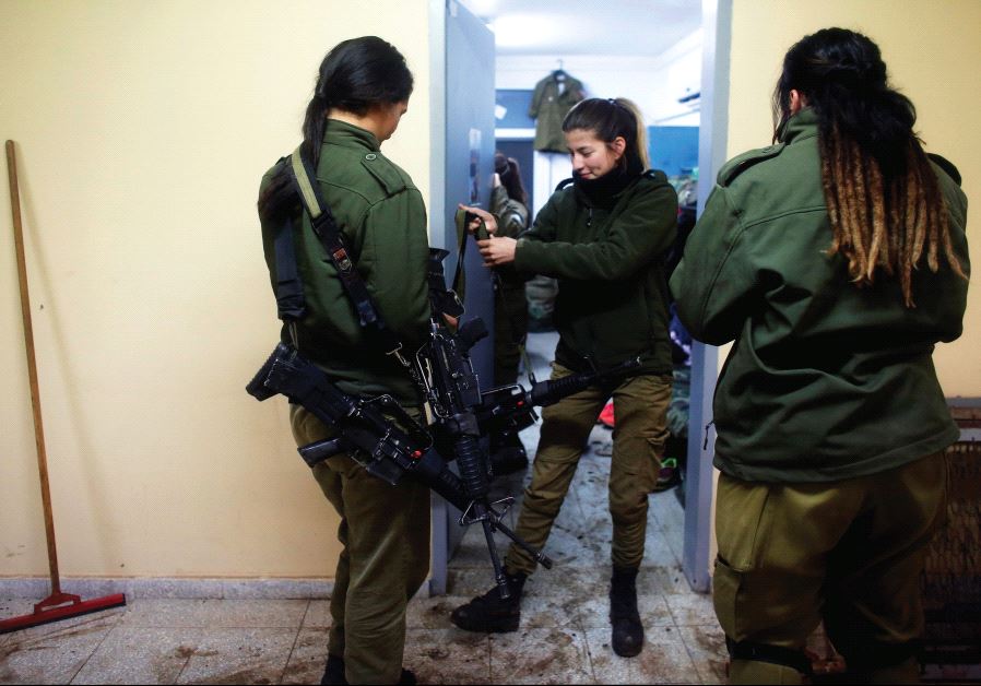 Female soldiers in an IDF artillery unit distribute weapons to their unit.