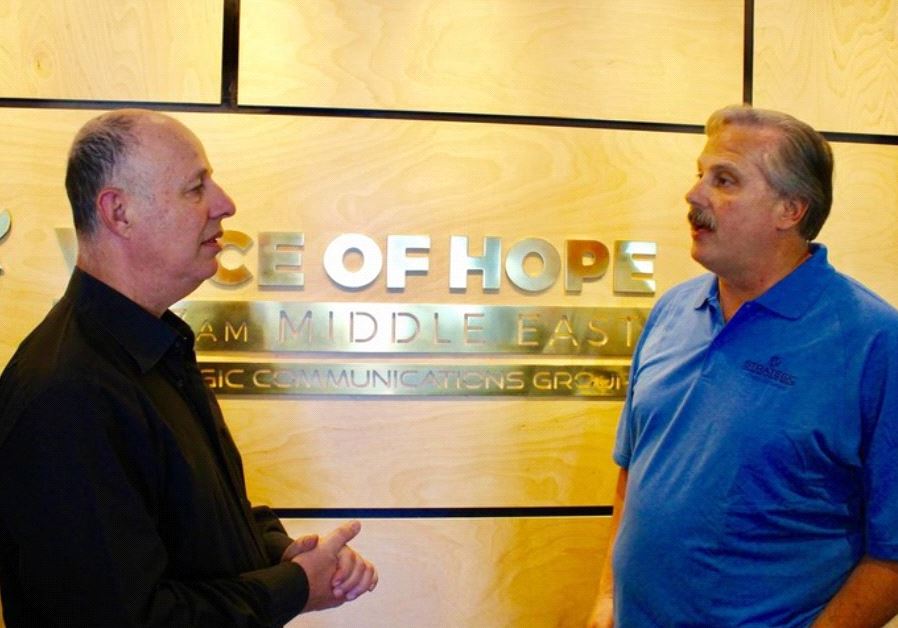 Communications Minister Tzachi Hanegbi meets with John Tayloe, founder and president of Strategic Communications Group, last week 